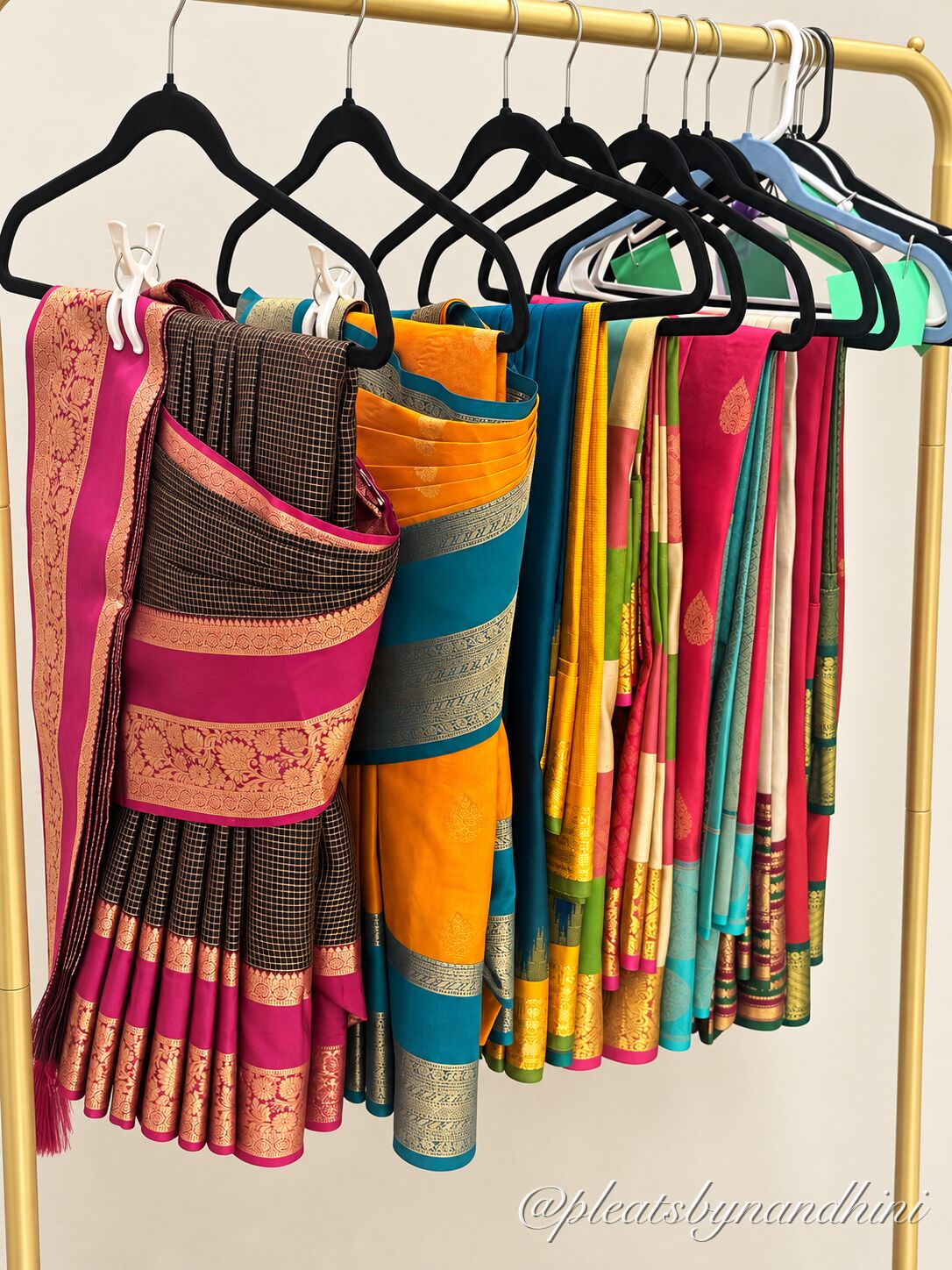 Pre-pleated sarees hanging on a rack